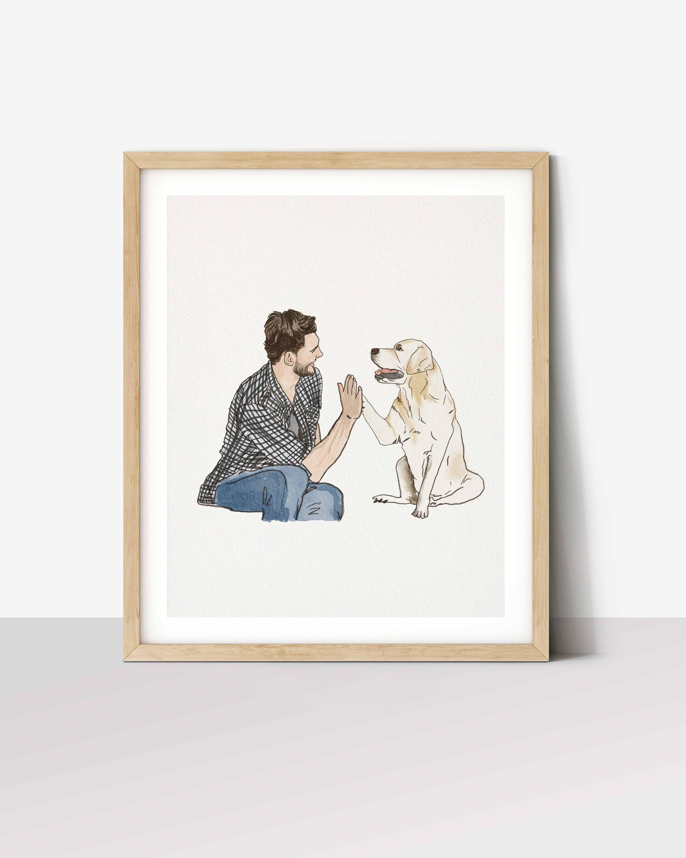 Framed watercolour portrait of a man high-fiving his golden retriever, painted from a photo
