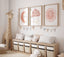 Pastel moon, cloud and sun prints above a nursery bench and toy giraffe