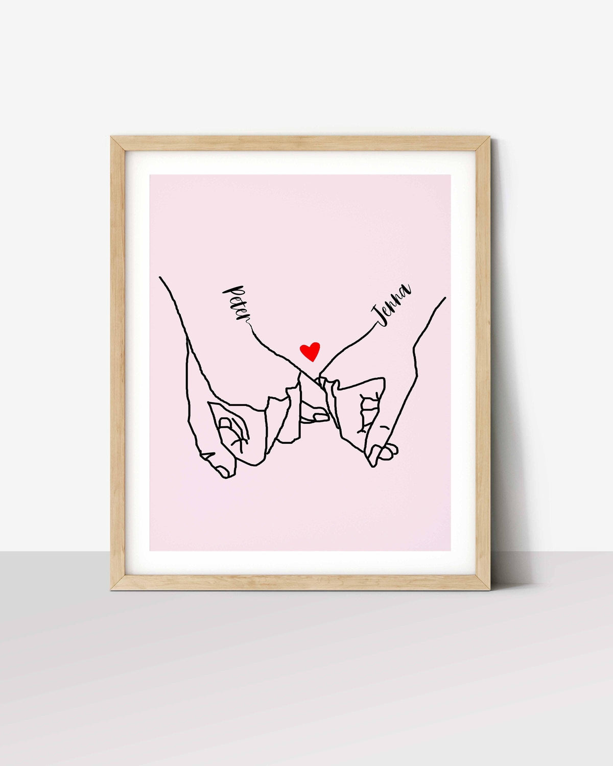 Pinky promise print: line drawing of two linked pinky fingers with names Peter and Jenna and a red heart, on pink