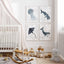 Four navy ocean animal prints as a grid in a nursery with a rocking horse