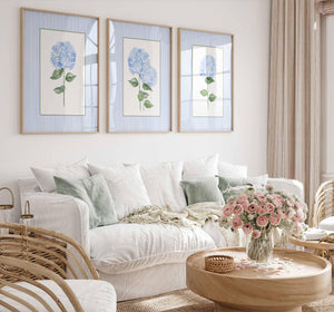 Blue hydrangea prints on blue stripes above a white sofa